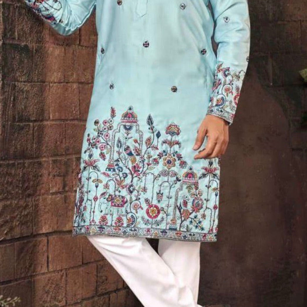 Light blue kurta with floral patterns worn by a person against a brick wall.