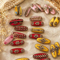 Collection of colorful decorative items on a textured surface